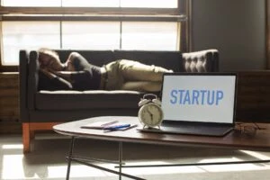 unrecognizable black woman sleeping on couch near laptop